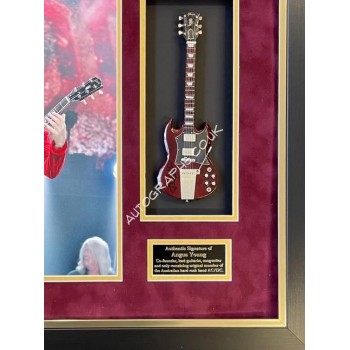 Angus Young AC/DC genuine authentic autograph guitar signed display. COA UACC Angus Young AC/DC genuine authentic autograph guitar signed display. COA UACC